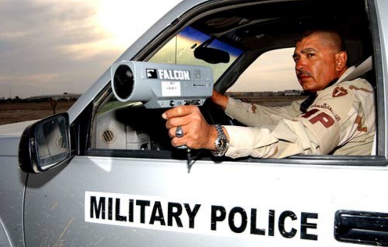 U.S. Army soldier using a radar gun, an application of Doppler radar, to catch speeding violators.